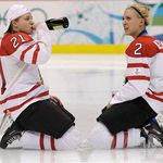 Haley Irwin (21) and Meghan Agosta (2) drink champagne